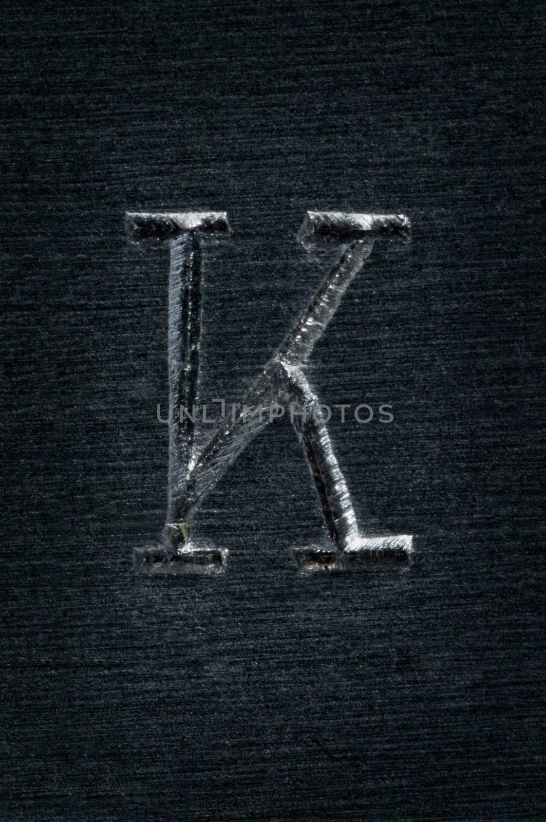 Macro image of the letter "K"" in metal"