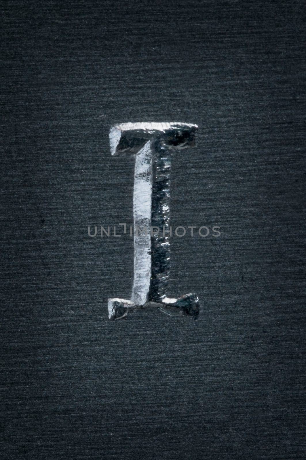 Macro image of the letter "I"" in metal"