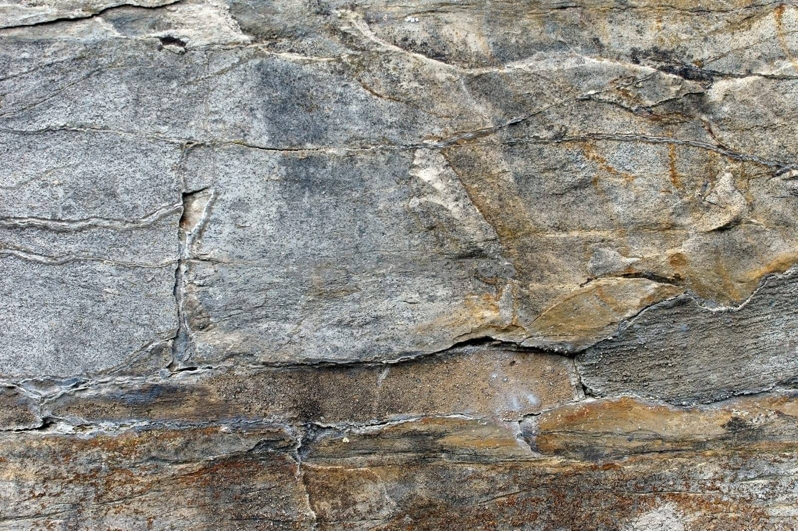 The photograph of an old iron-containing wall with rust.