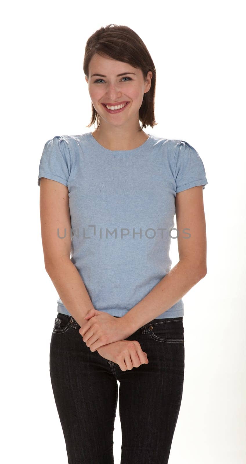 Studio photo of pretty young adult woman standing against white background