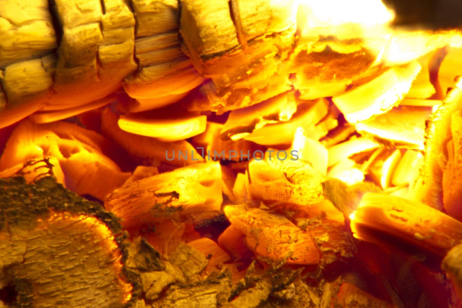 Fire place detail of a fire burning inside.