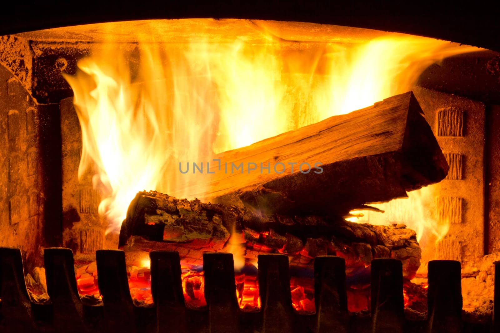 Fire place detail of a fire burning inside.