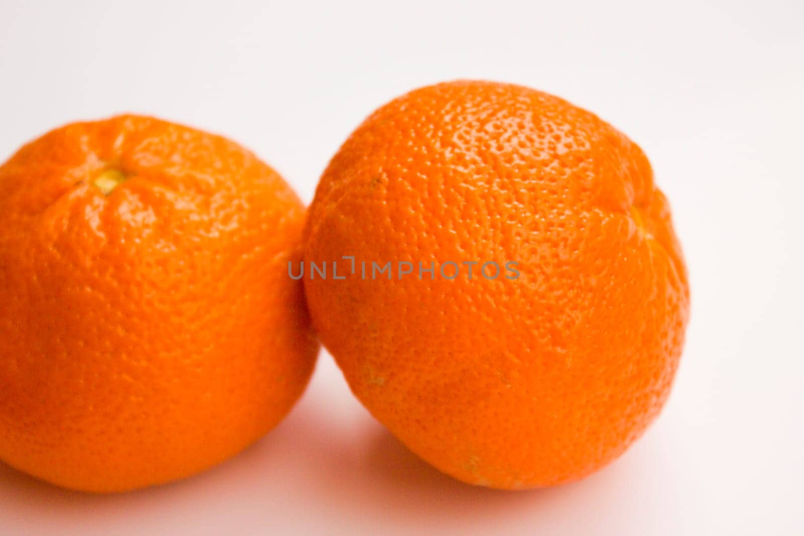 Vibrant mandarin fruit on a white background.