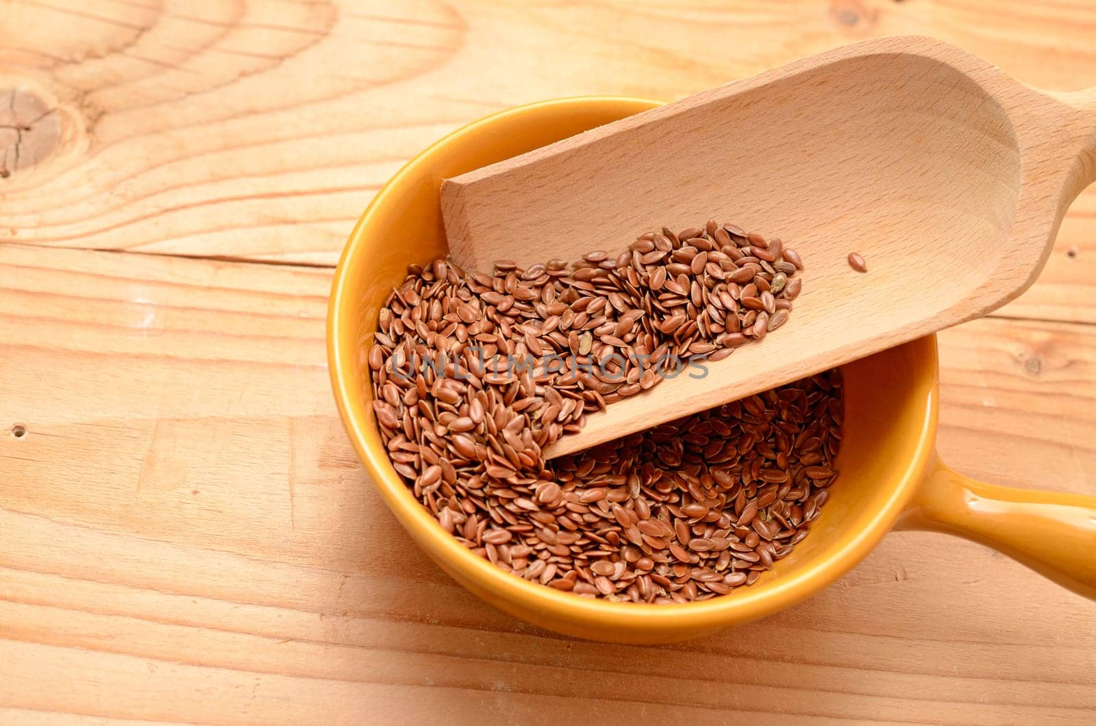 Flaxseed in a ceramic bowl on a wooden table