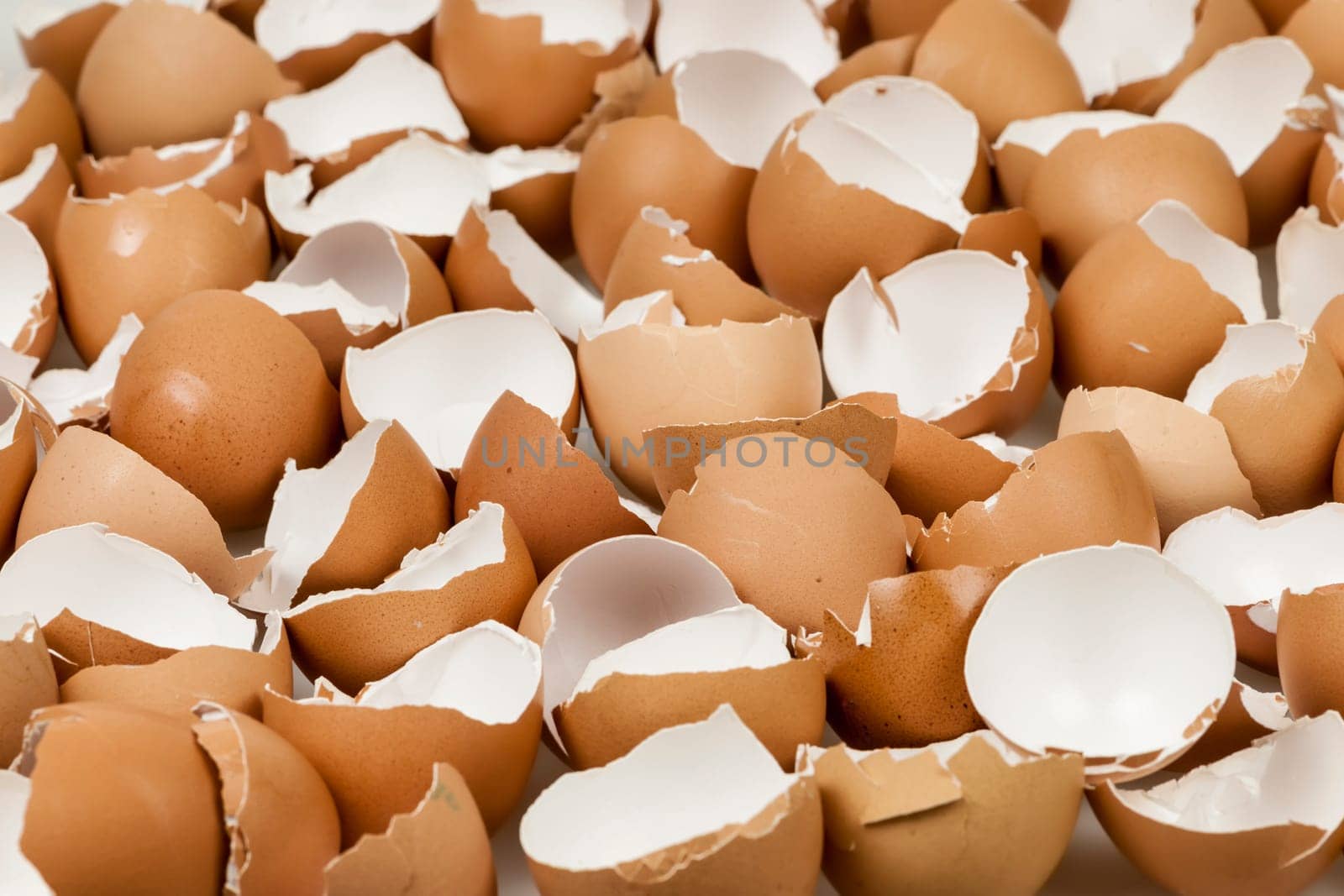 Background of many broken brown empty eggshells