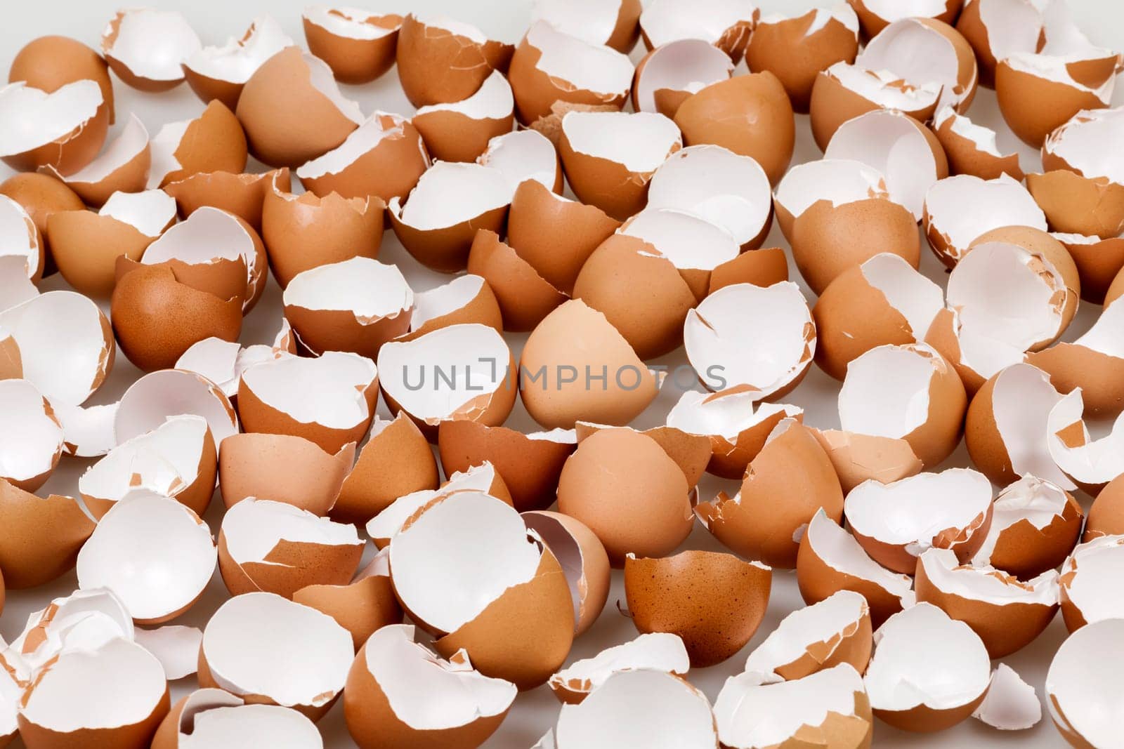 Background of many broken brown empty eggshells