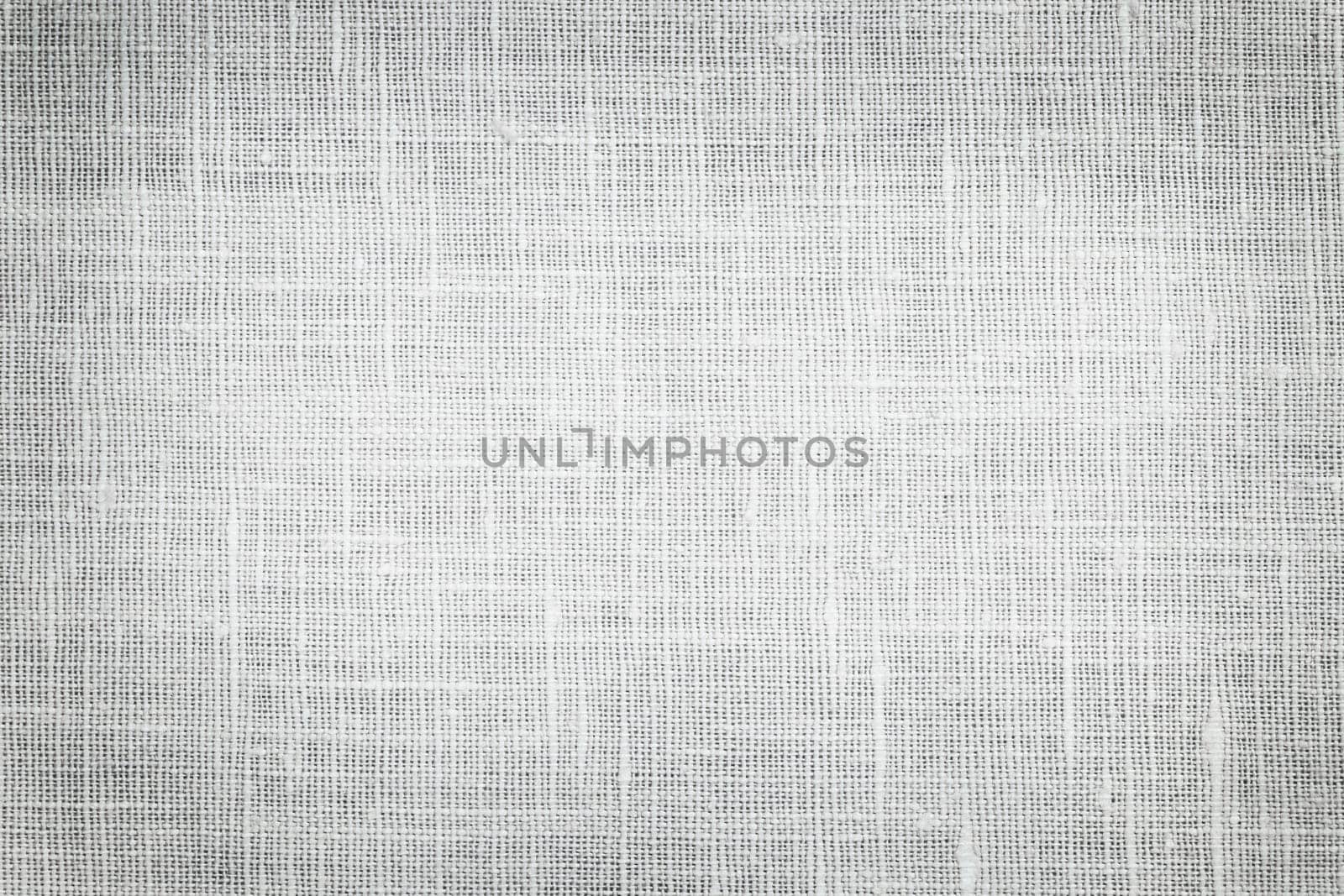 White linen woven fabric background or texture with dark vignette