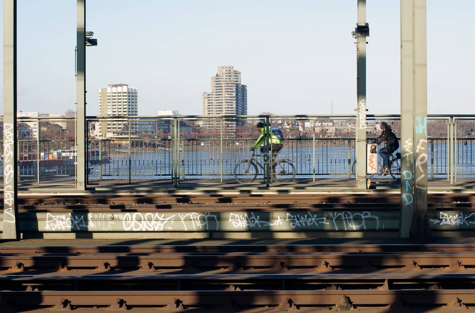 Cologne,Germany – February 02,2014: Two cyclists cross the Hohenzollern Bridge over the Rhine River on February 2,2014 in Cologne.