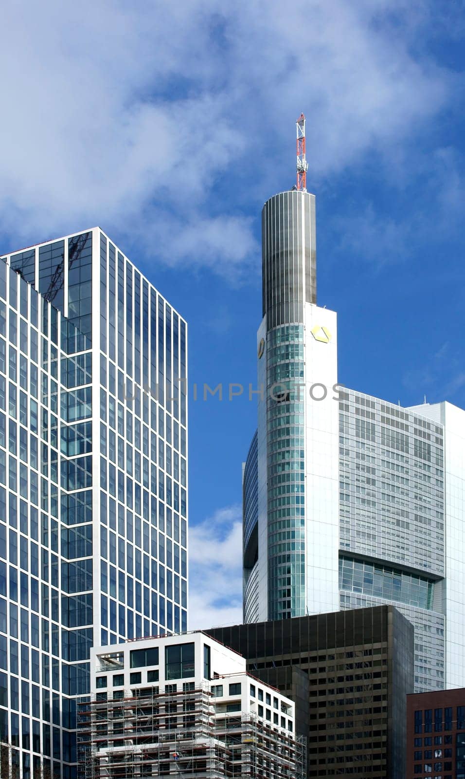 Frankfurt,Germany – February 19,2014: The commerzbank skyscraper between office buildings on 19 February 2013 in Frankfurt.