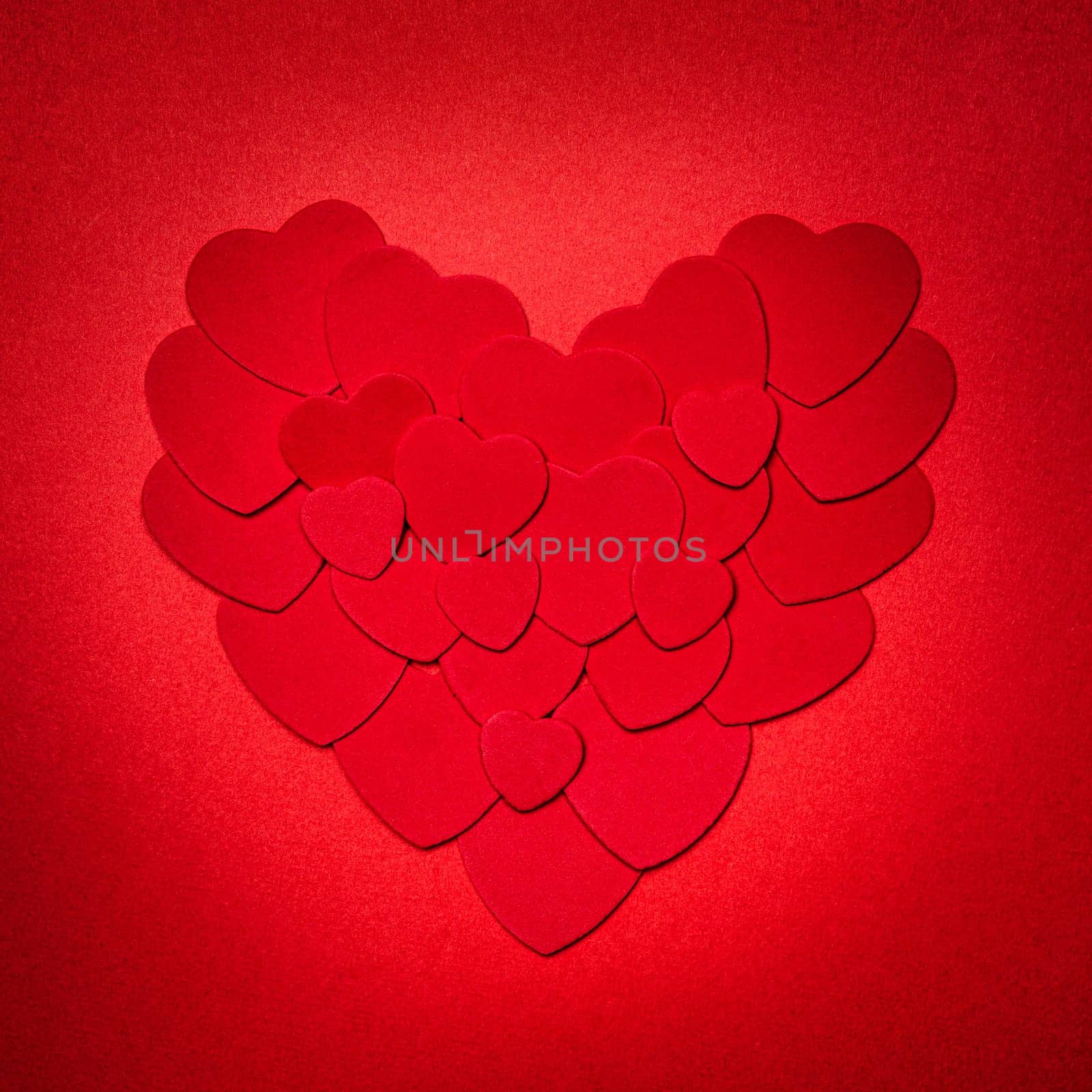 Romantic heart made of many smaller red paper hearts for valentines day