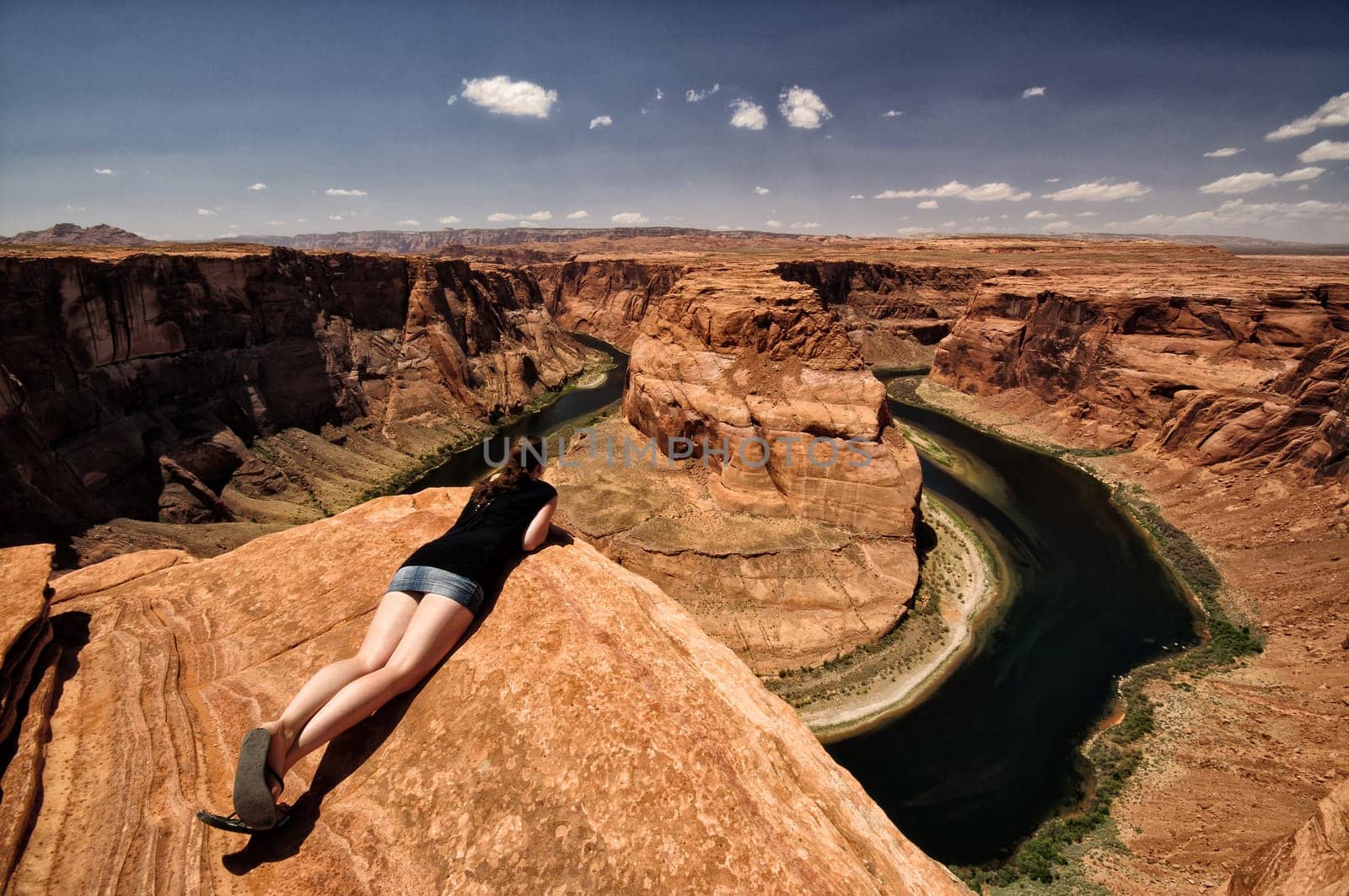 Woman looks over the edge of the abyss at the Grand Canyon,Arizona,USA