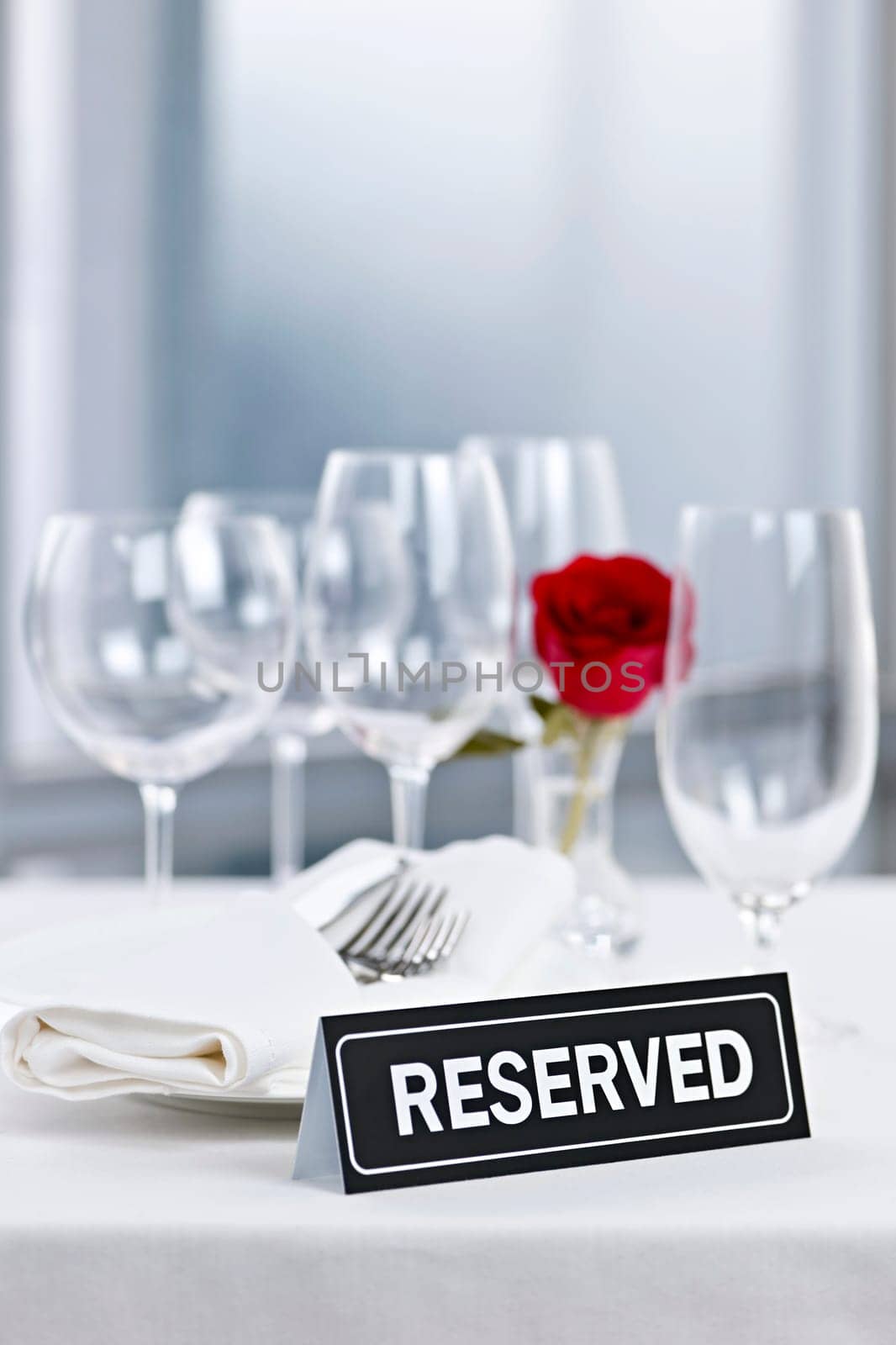 Reserved romantic table setting with roses plates and cutlery