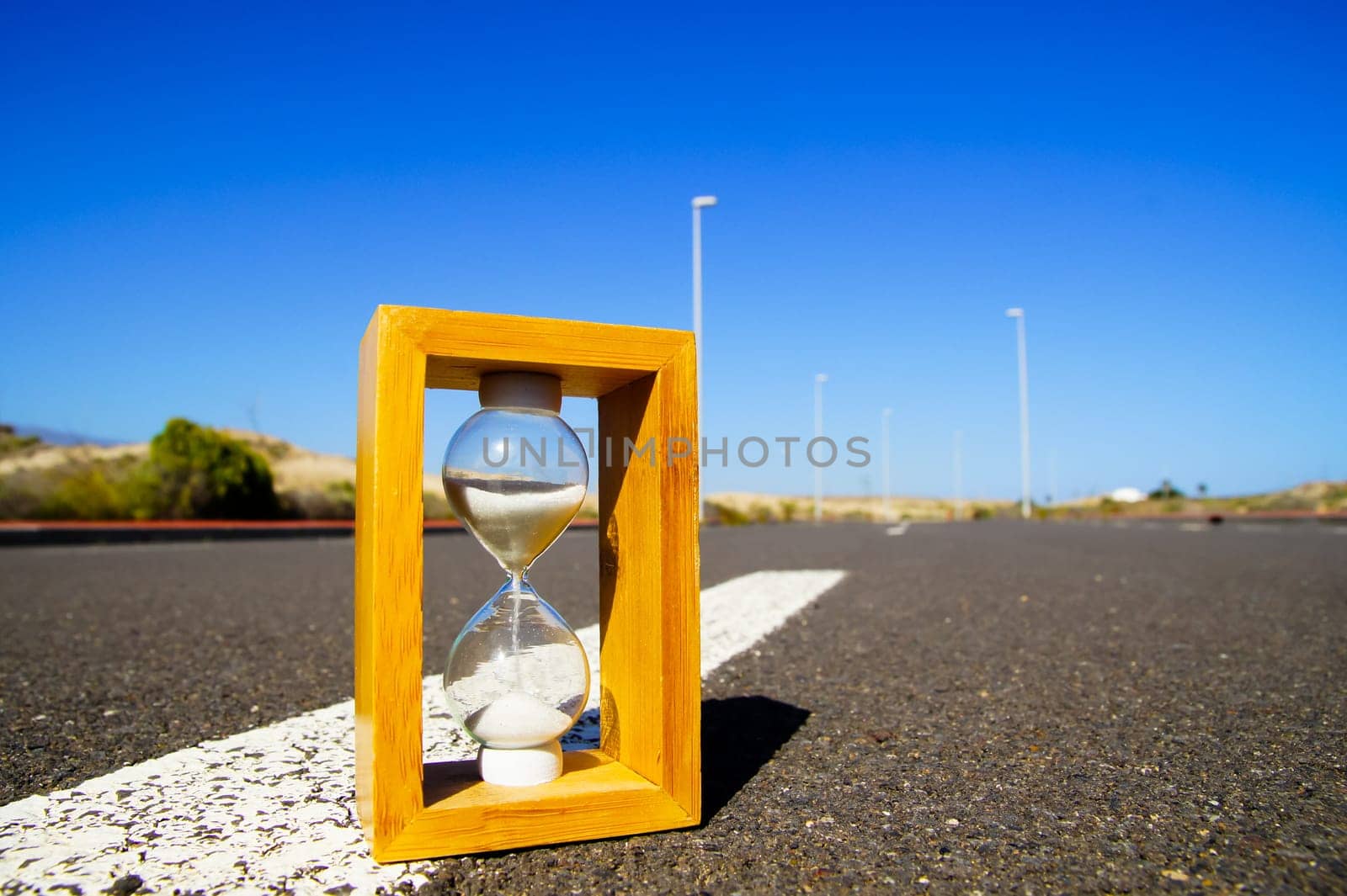Time Concept Hourglass on the Asphalt Street