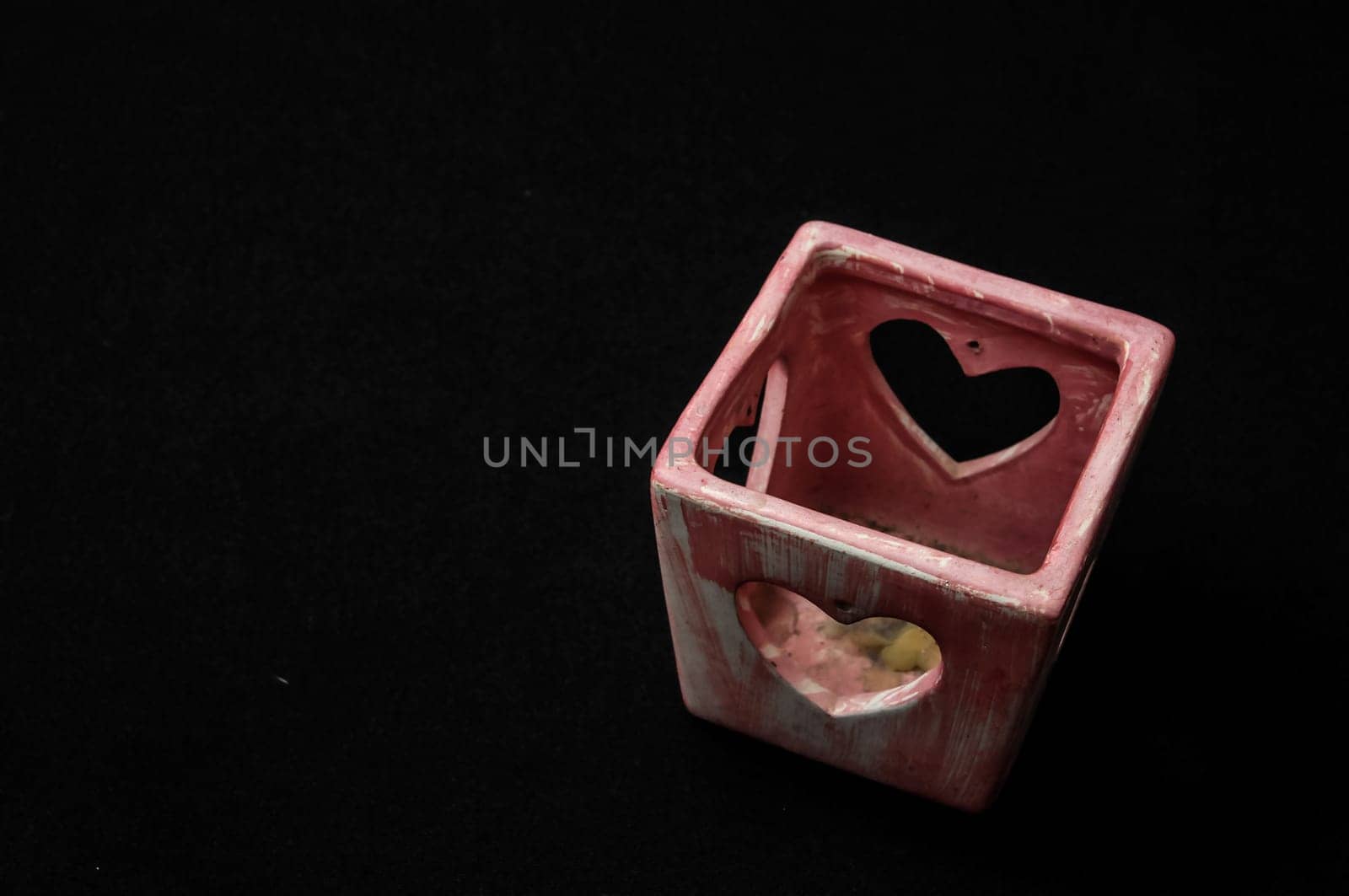 Colorful designed clay vase over a Black background