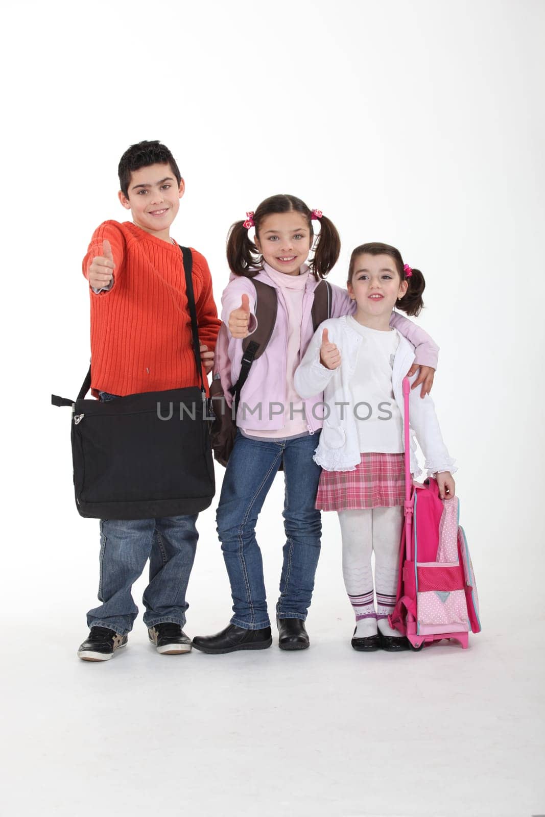 Three schoolkids with bags