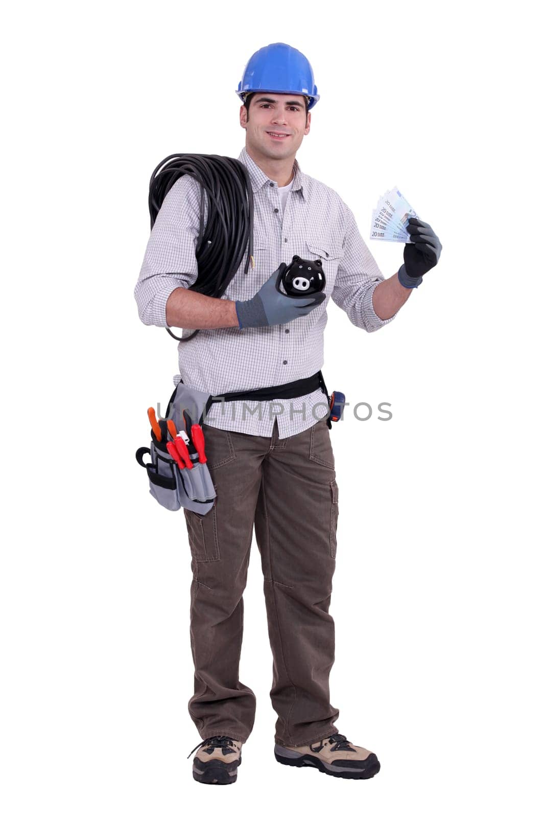 Construction worker holding a piggy bank and money