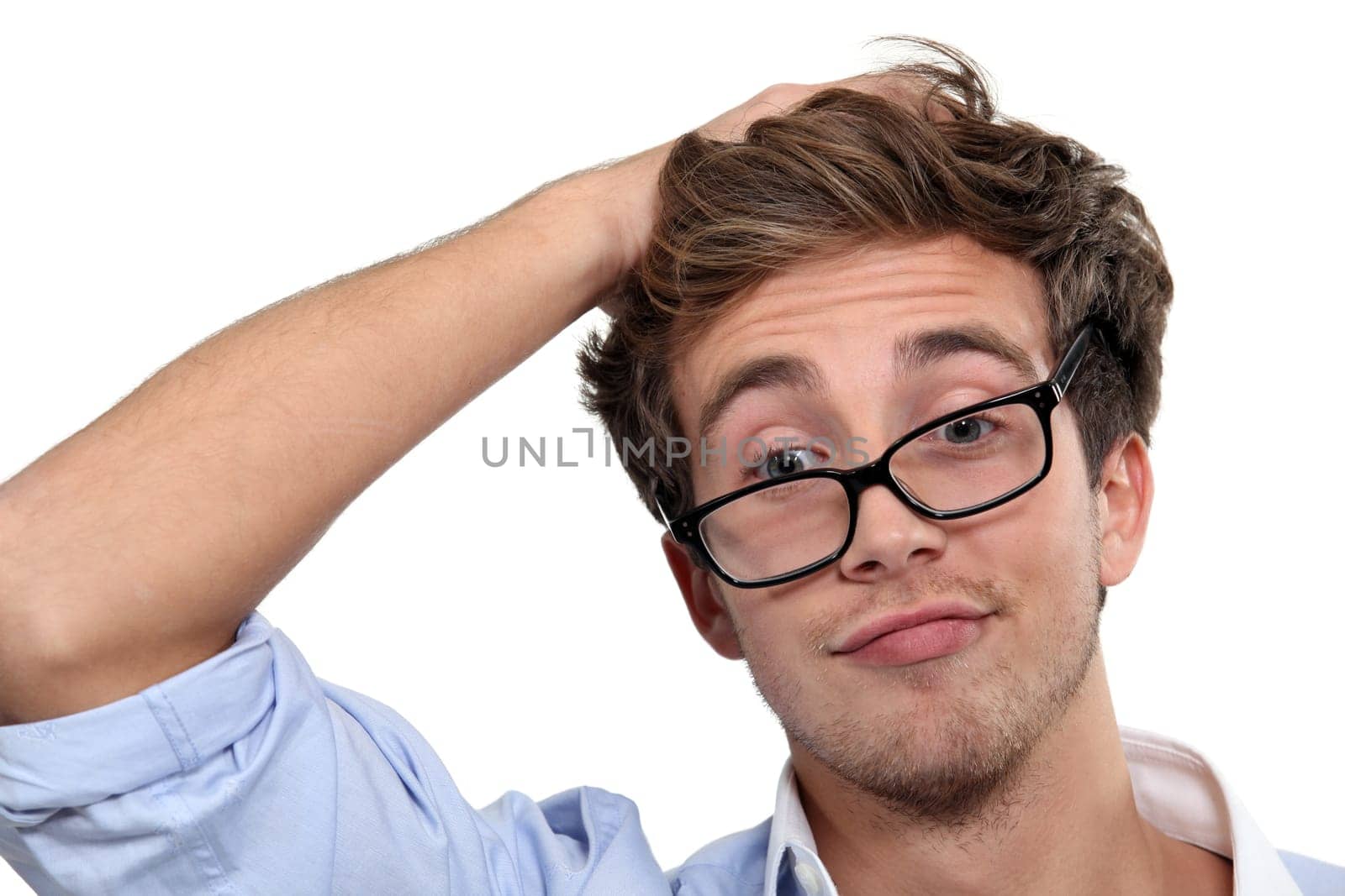 young man wearing glasses making a funny face
