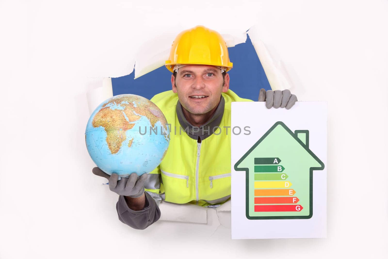 Tradesman holding a globe and an energy efficiency rating chart