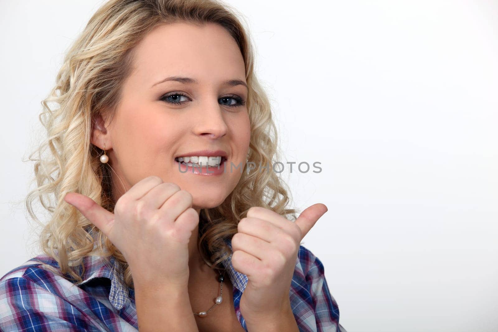 blond woman doing thumbs-up gesture