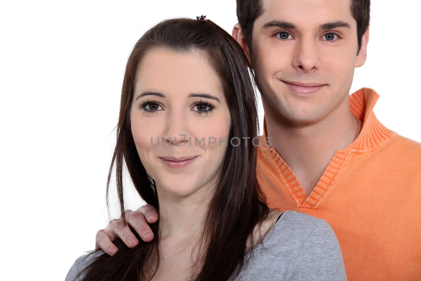 Young couple playing a guitar at home