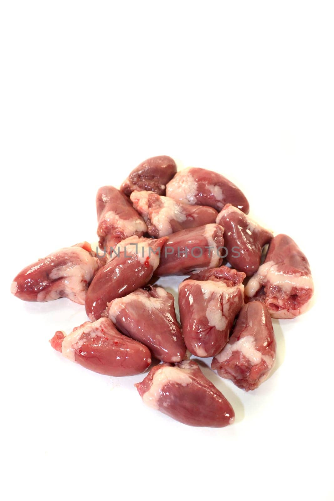 fresh raw chicken hearts against a white background