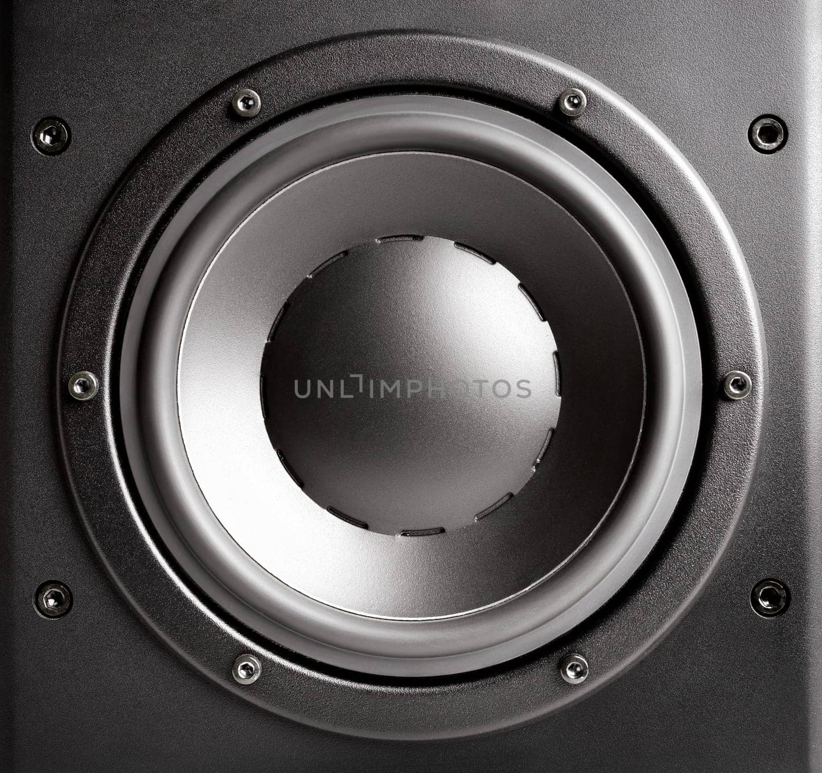 A black,brightly lit loudspeaker box in close-up