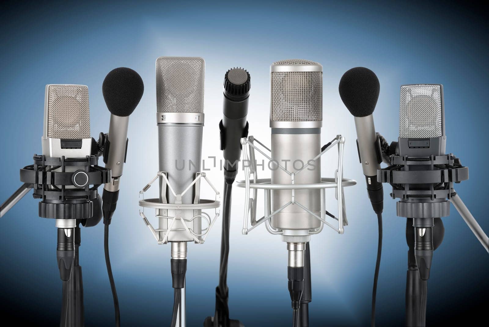 Studio recording from a set of professional microphones against a blue background