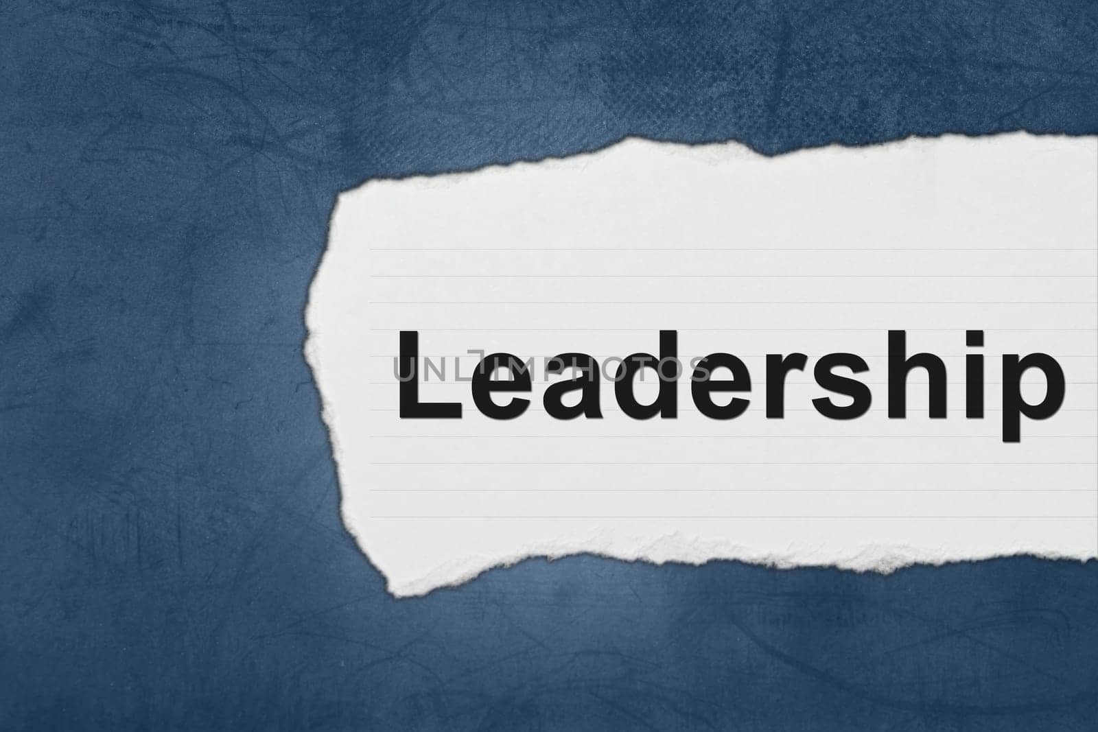 Leadership with white paper tears on blue texture