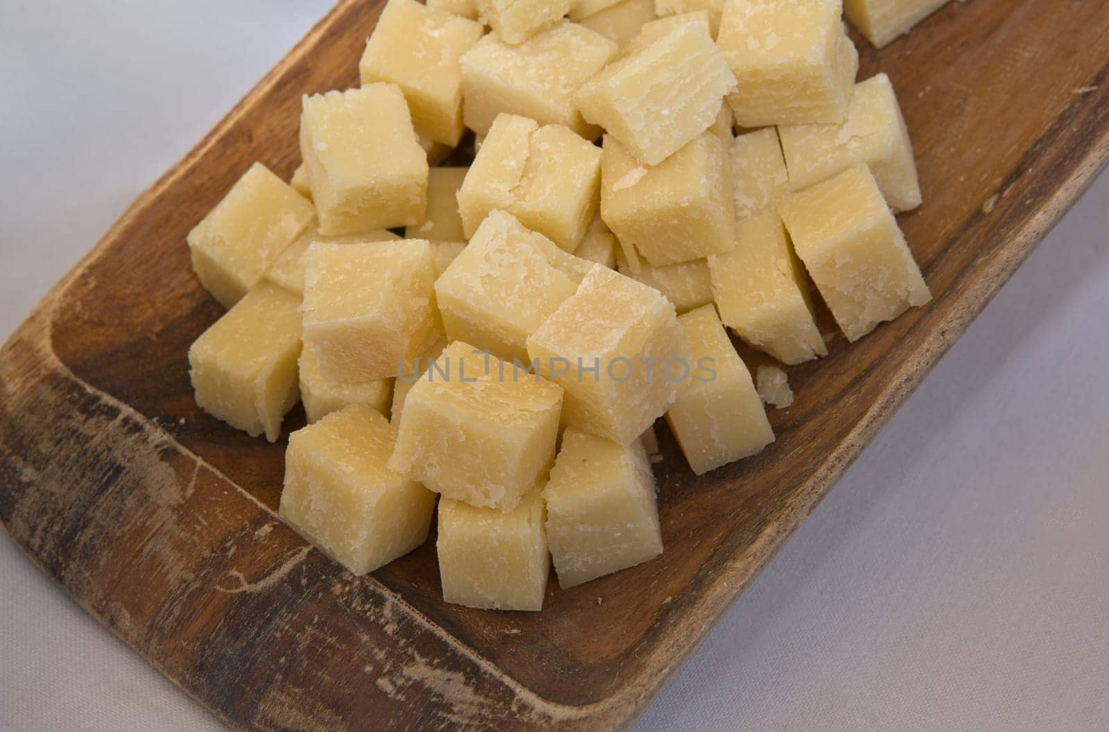 Cubes of aged sheep cheese on a wooden tray, Caceres, Spain