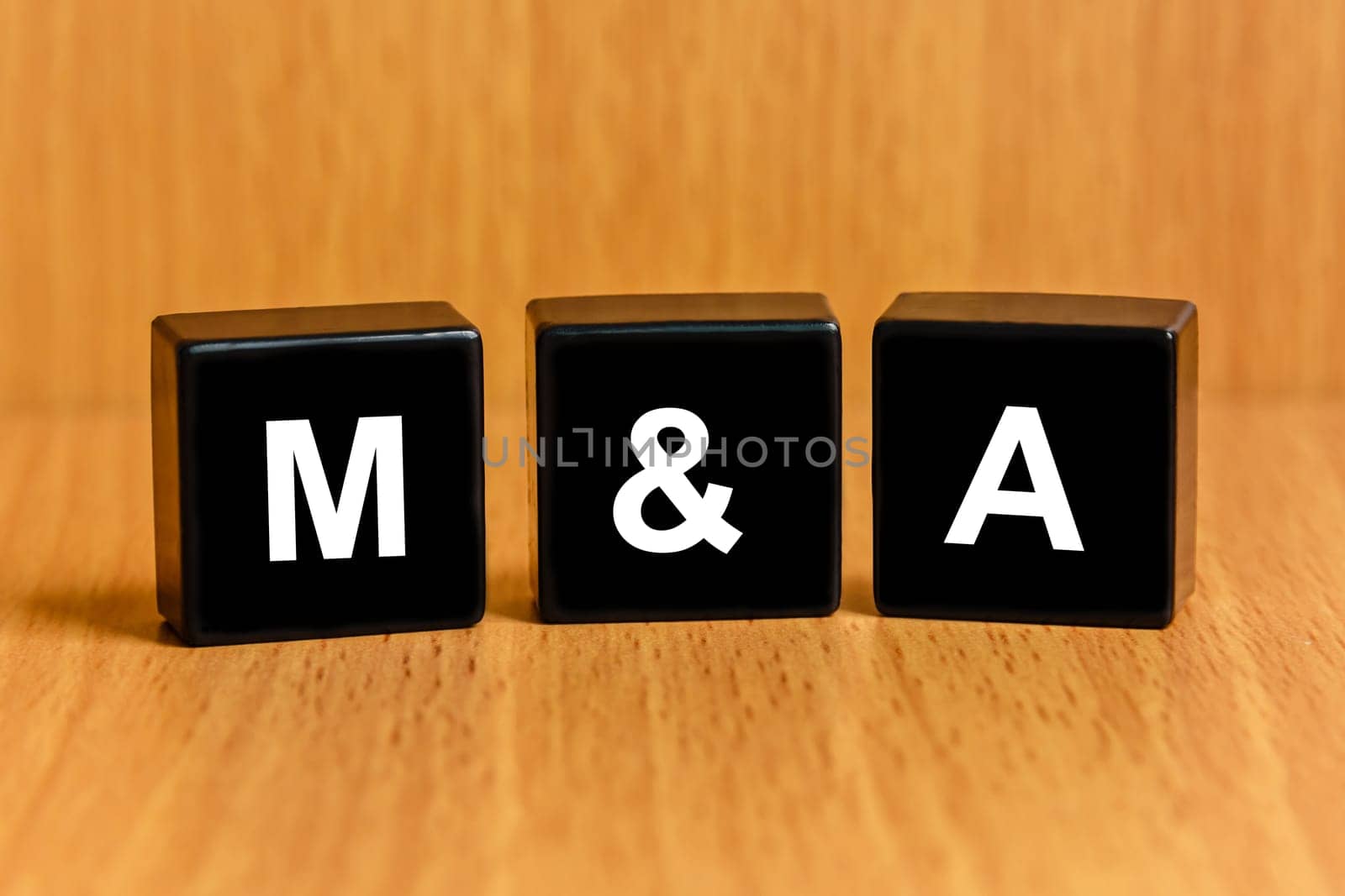 M&A or Merger and Acquisition text on black block