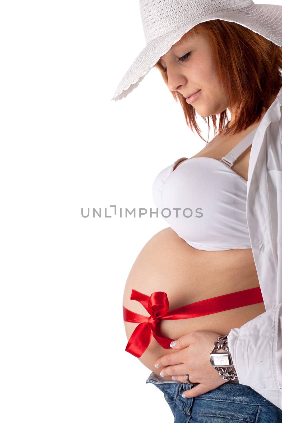 modern pregnant woman with hat and red bow