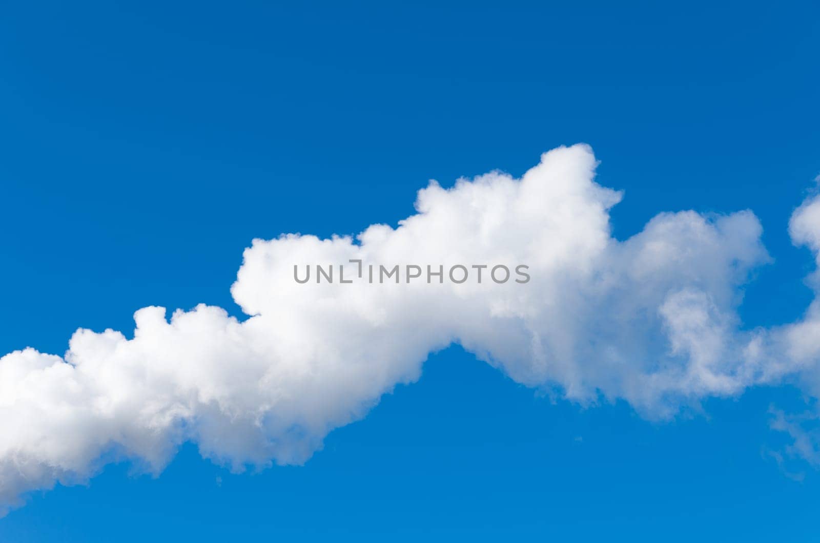 line of white smoke against a blue sky