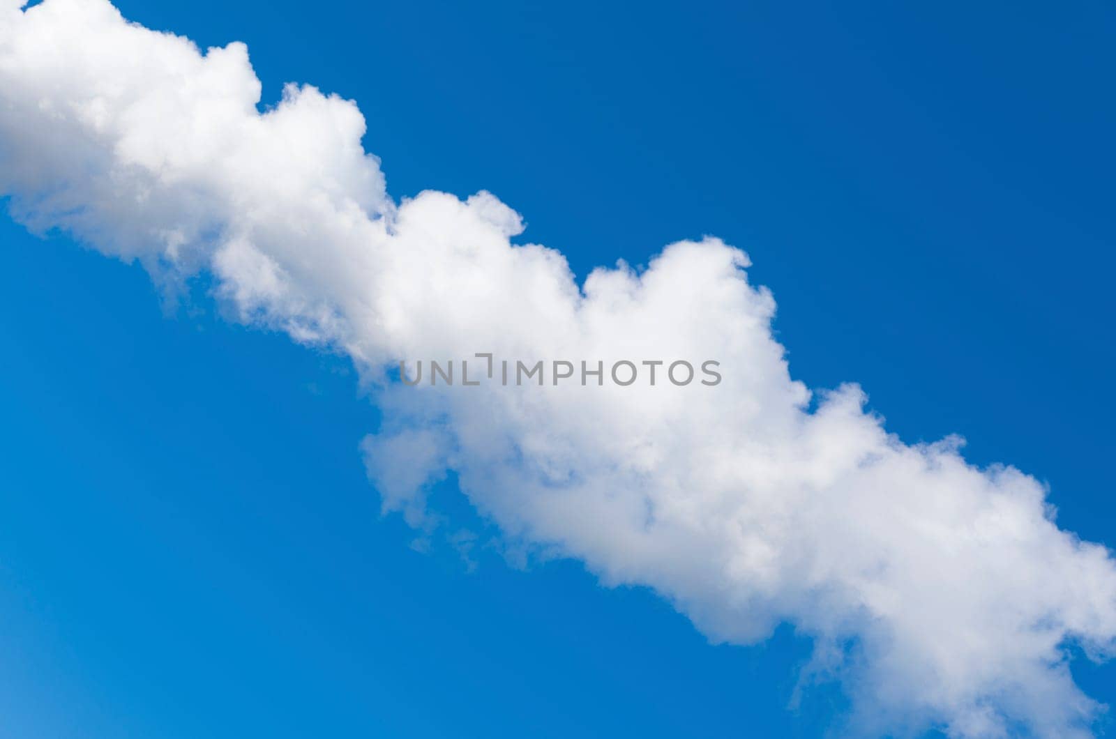 line of white smoke against a blue sky