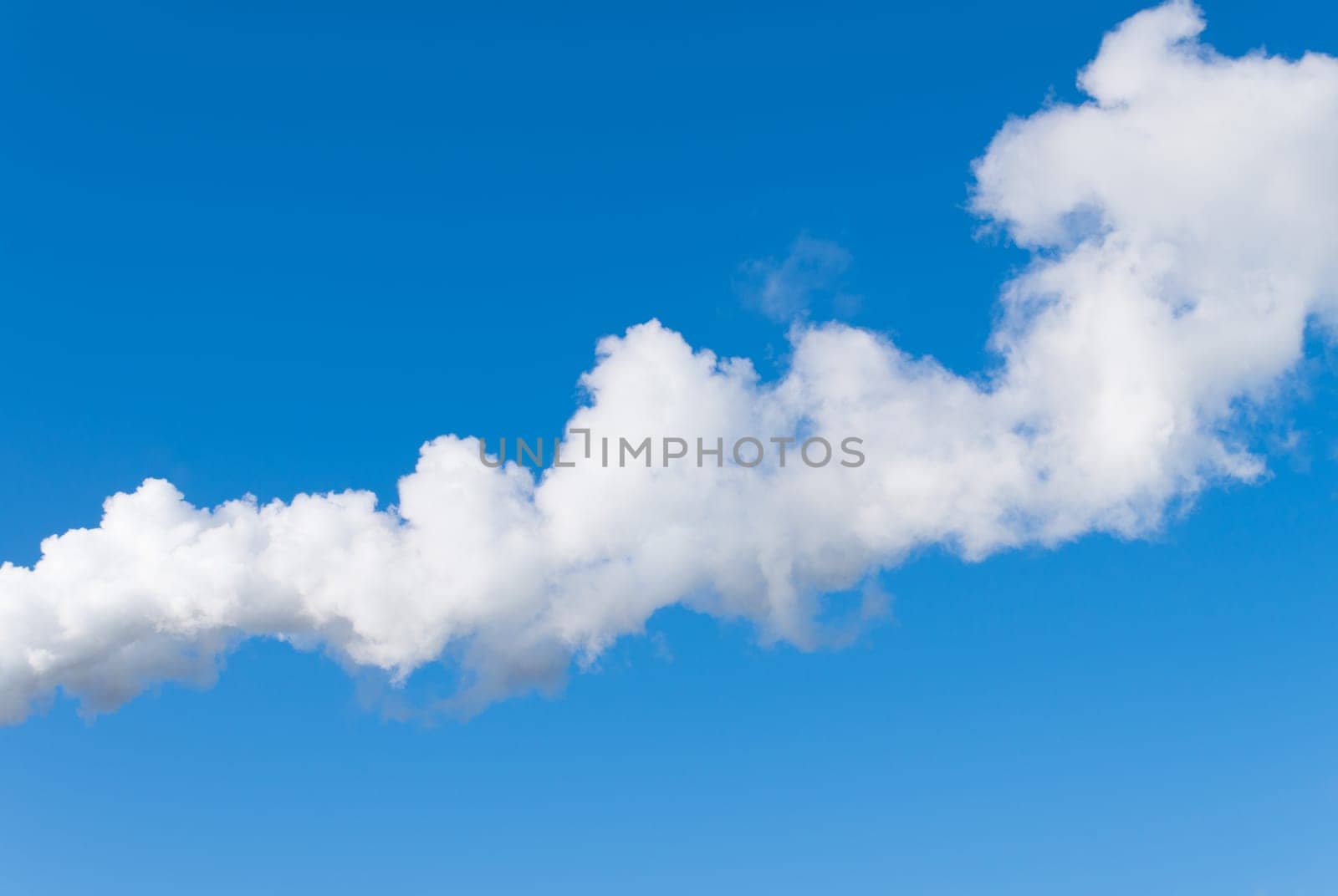 line of white smoke against a blue sky
