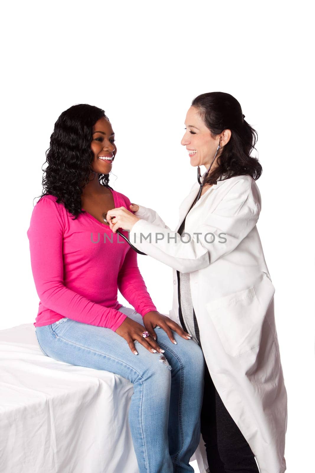 Happy smiling doctor physician listening to patient teenager woman heartbeat with stethoscope, isolated.