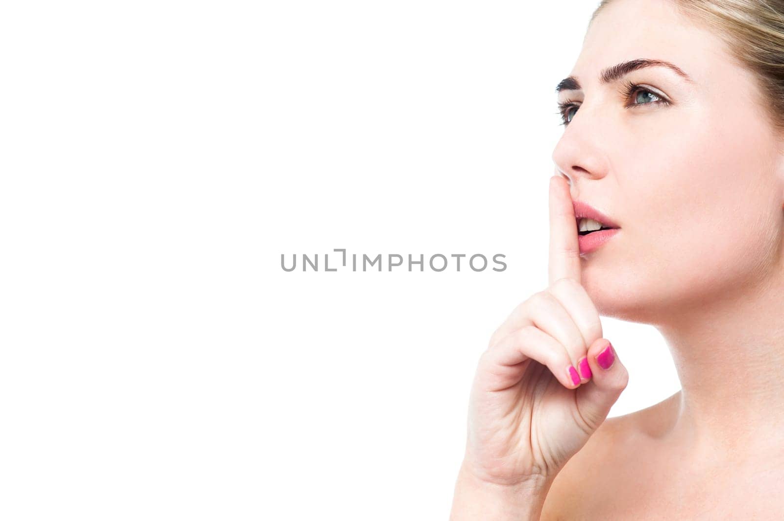 Attractive woman making a shushing gesture