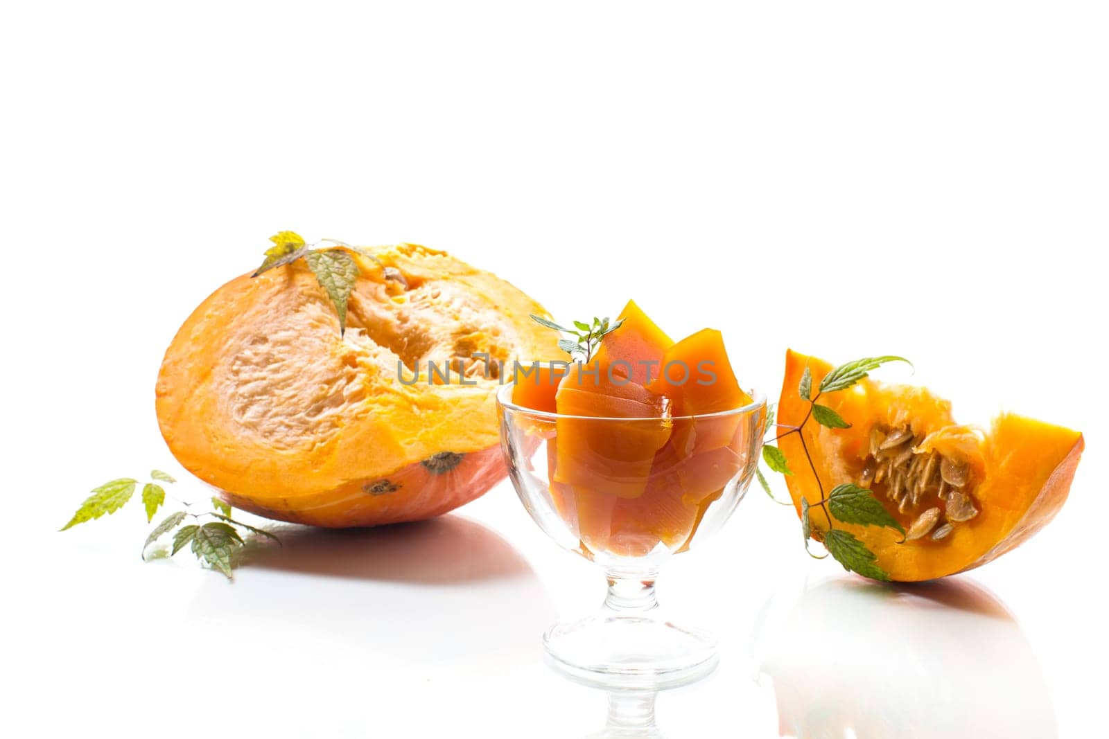 Prepared sweet pumpkin marmalade in a glass bowl isolated on a white background. Autumn recipes.