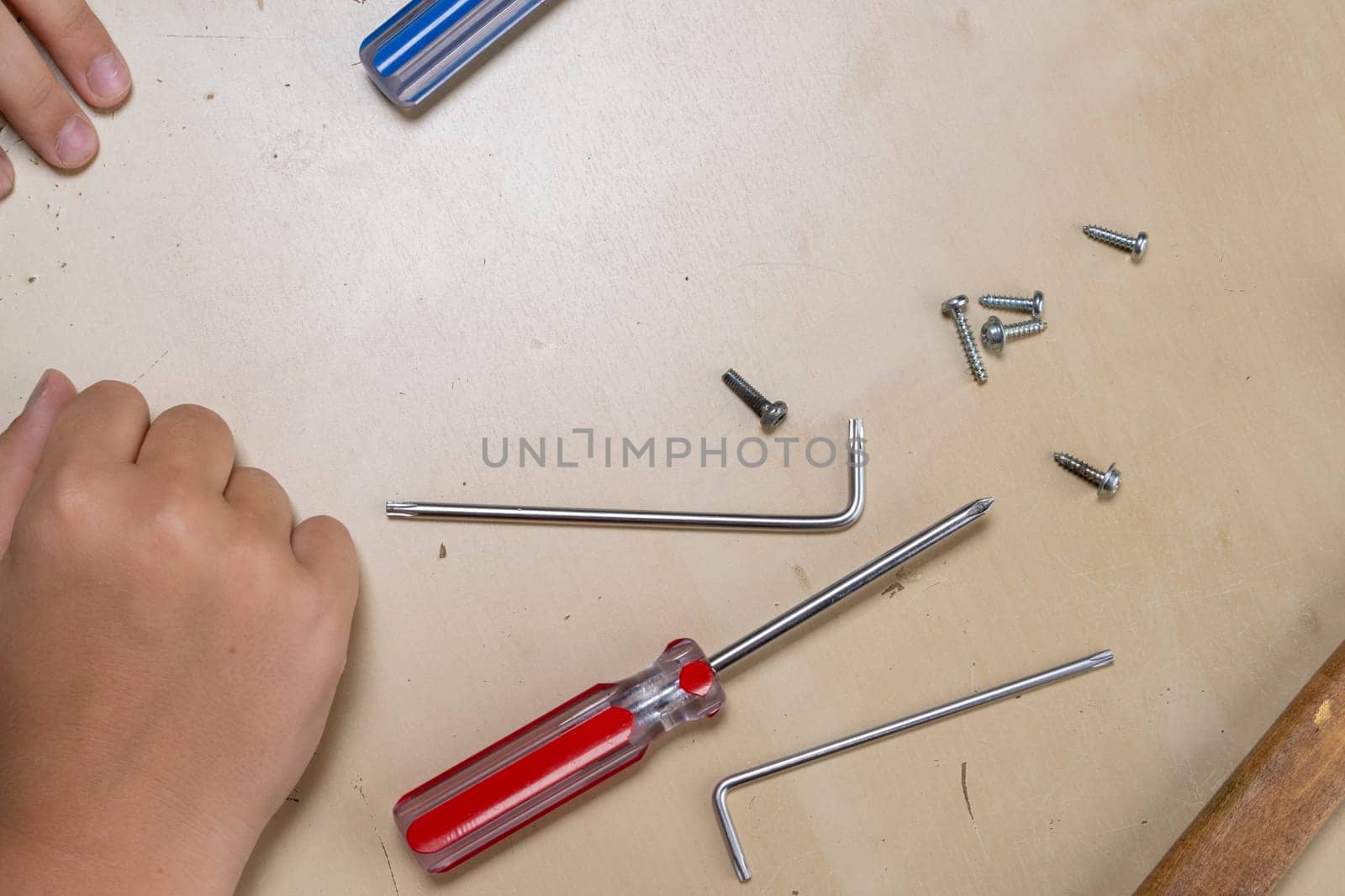 master repairs the iron in the workshop on the table using tools by audiznam2609