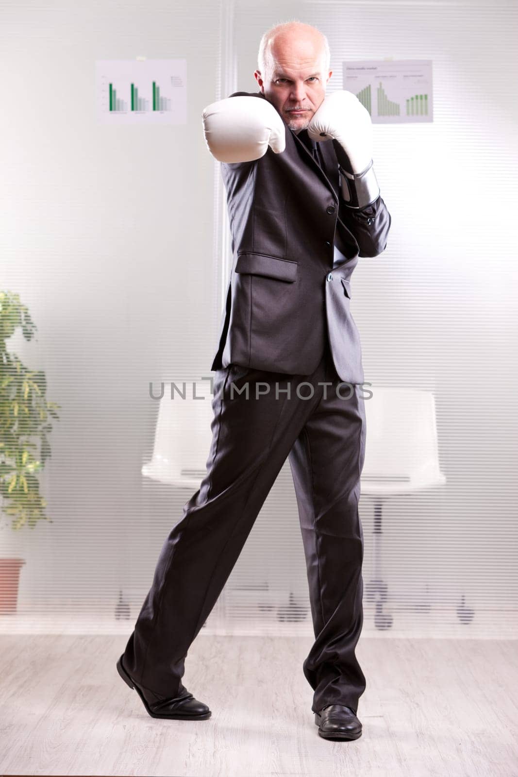 fighting business man upright and ready with white gloves
