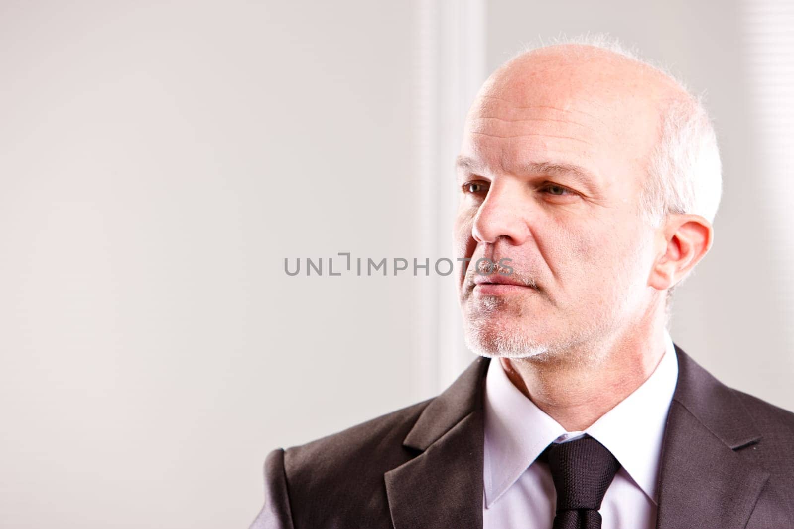 middle aged businessman looking into the future (looking left)