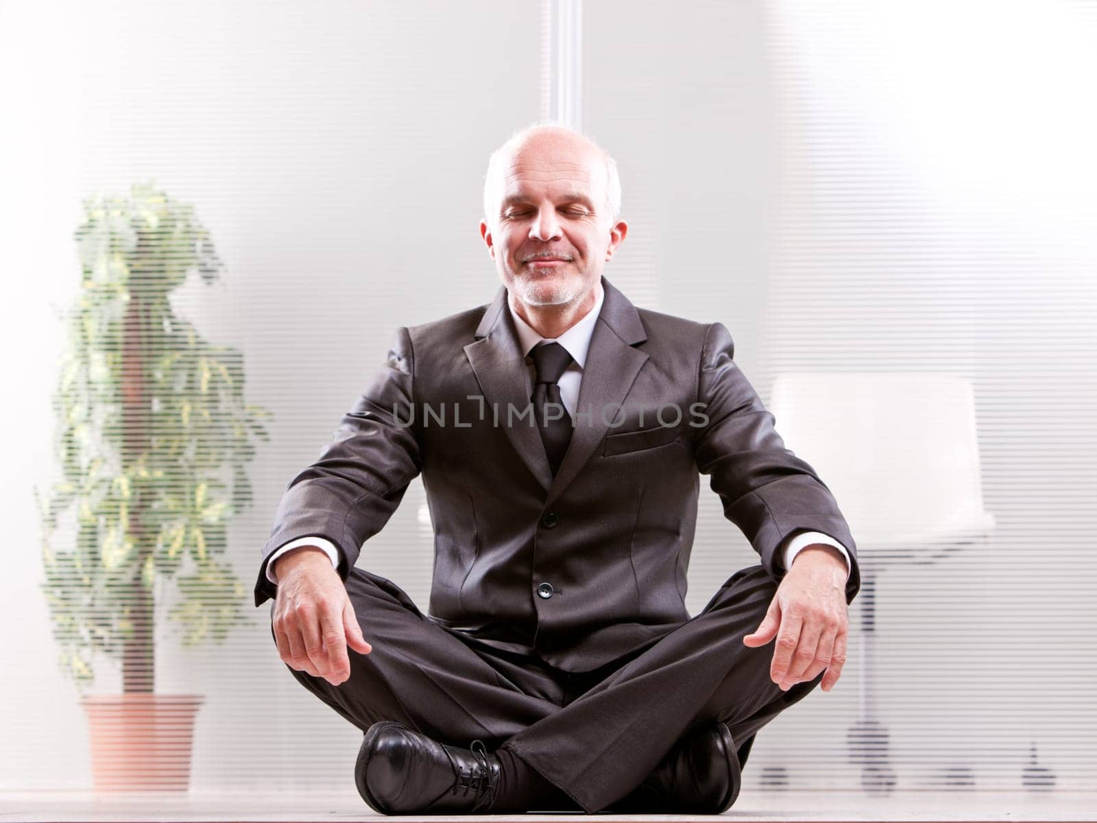 meditating Relaxed businessman smiling with his eyes closed