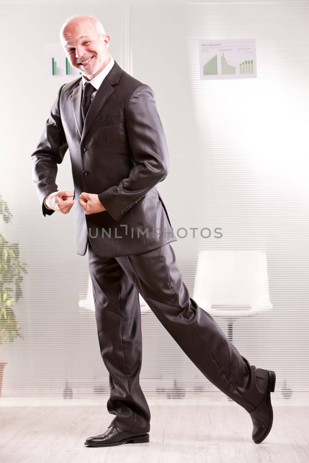 Goofy businessman pretending weightlifting  with his arms and foolish face