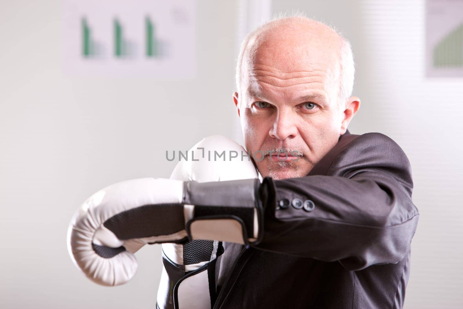 fighting business man upright and ready with white gloves