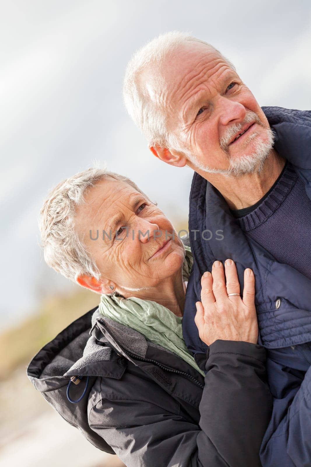 older adult happy couple walks on the beach in autumn lifestyle happiness