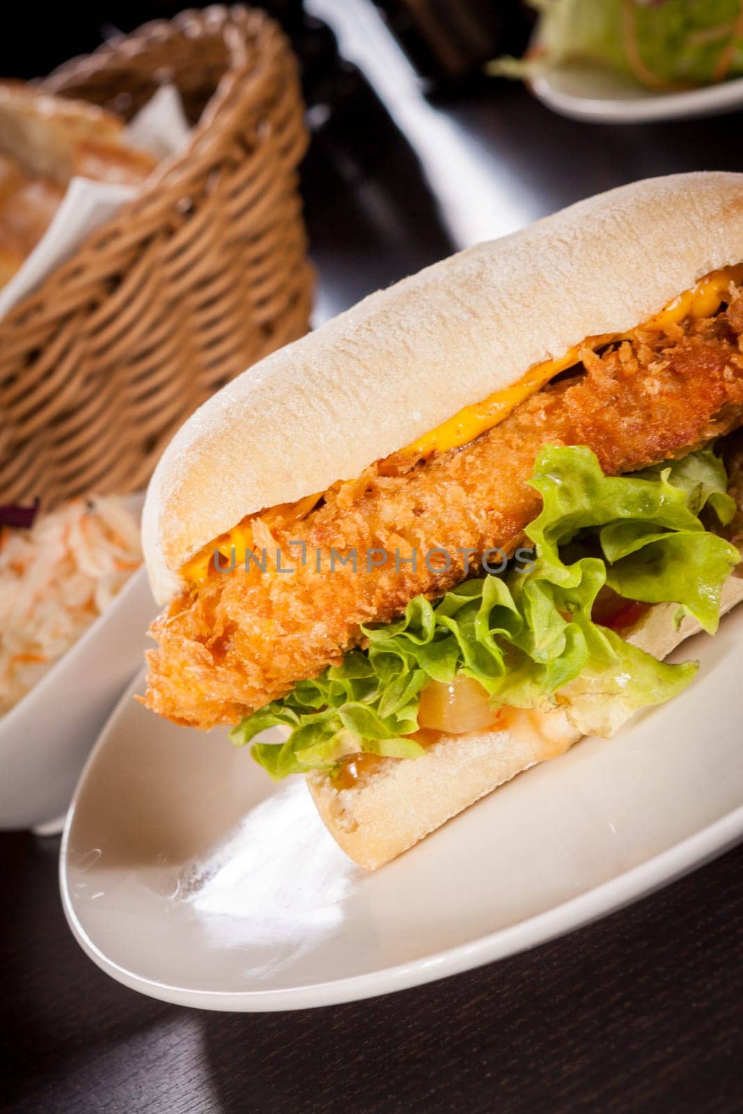 Chickenburger with chicken meat and salad as a close-up on a plate