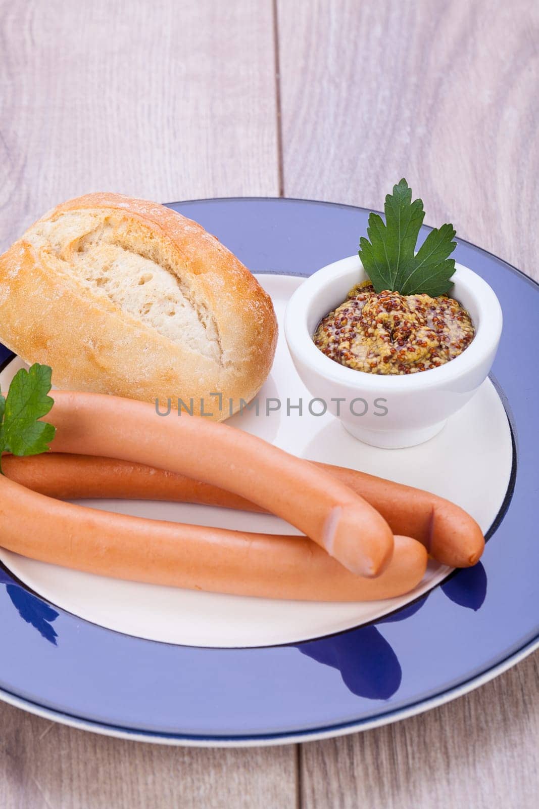 hot wiener sausage with mustard and fresh dark farmer's bread