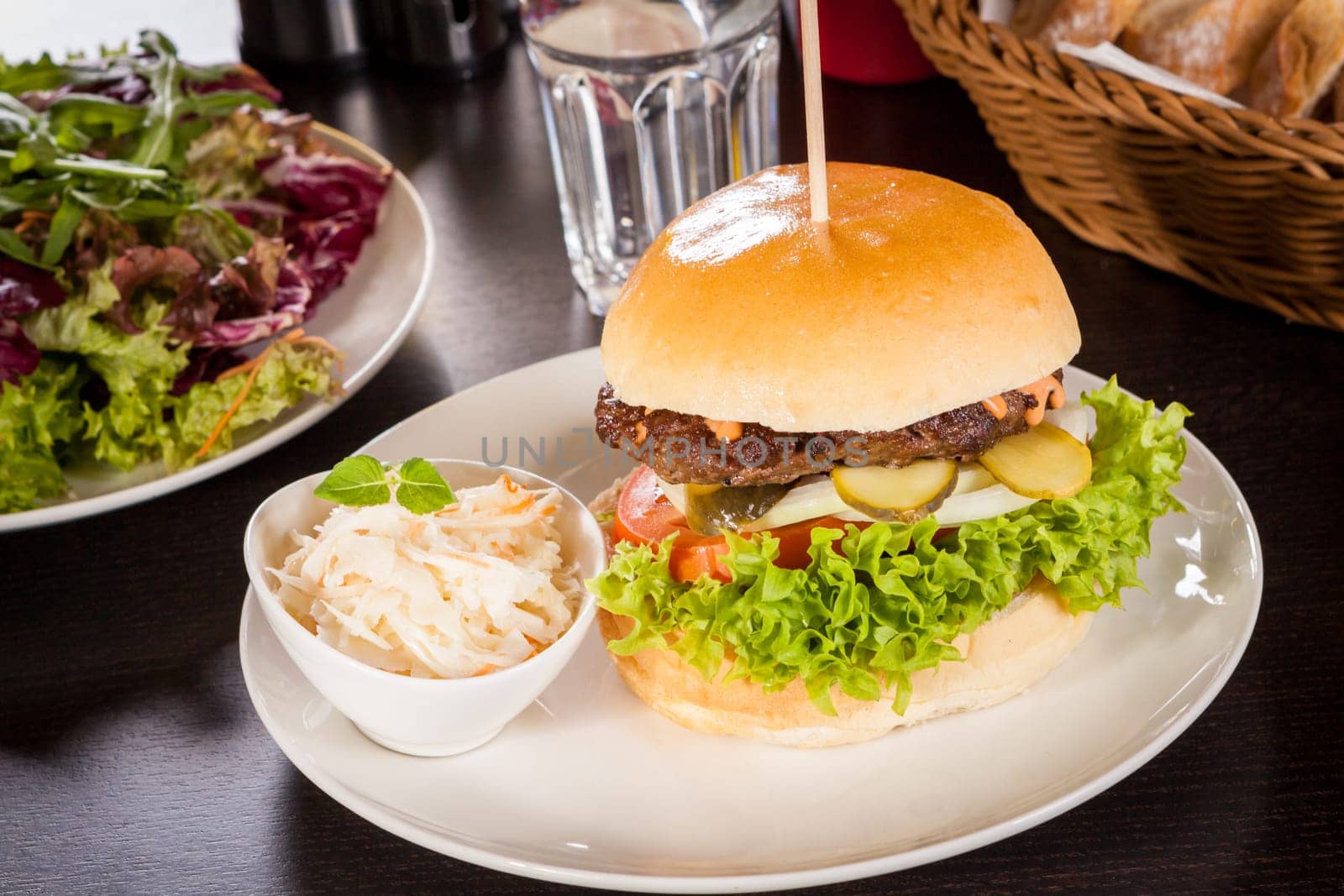 Delicious hamburger cheeseburger with bacon egg and salad on a plate