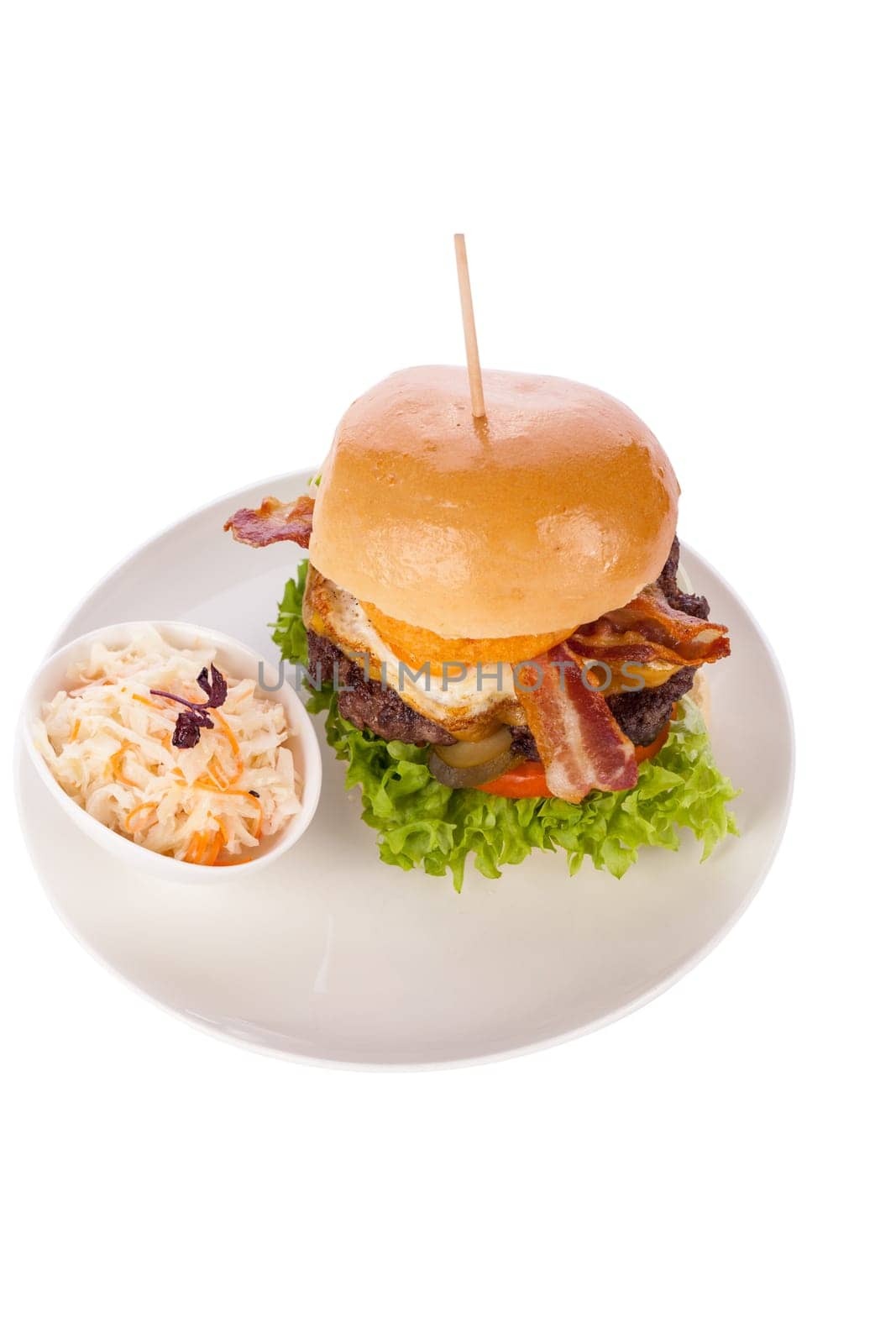 Delicious hamburger cheeseburger with bacon egg and salad on a plate isolated on a white background