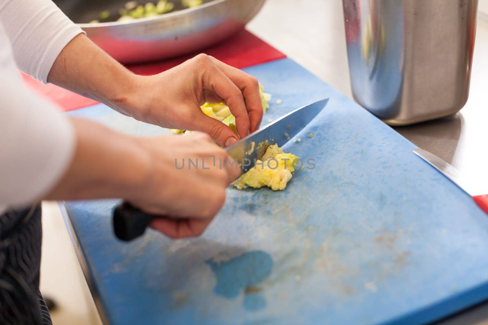 chef cuts fresh green vegetables in the restaurant kitchen food food cooking