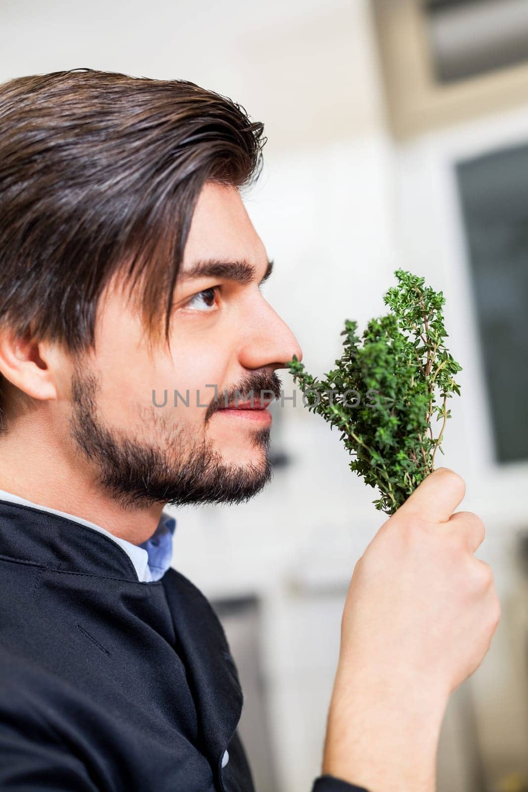 young chef in the restaurant kitchen with fresh arümatic spices